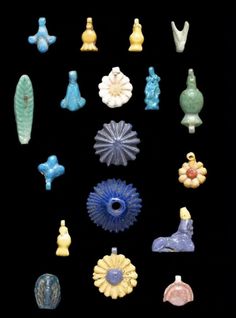 an assortment of small glass objects on a black background, all in different shapes and sizes