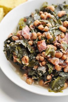 a white plate topped with beans and greens