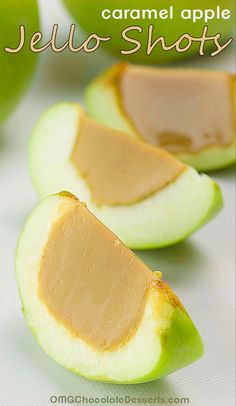 caramel apple jello shots are cut in half on a white surface with text overlay that reads, caramel apple jello shots