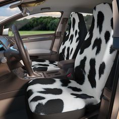 the interior of a car with black and white cow print seat covers on it's front seats