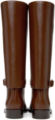 Calf-high buffed calfskin boots in brown. · Logo embossed at pin-buckle ankle strap · Fully lined · Topstitching at welt · Stacked leather heel with rubber injection · Leather sole · Silver-tone hardware · Heel: H1.5 in Supplier color: Pine cone brown Formal Brown Knee-high Boots With Reinforced Heel, Formal Brown Knee-high Boots With Almond Toe, Brown Almond Toe Knee-high Boots For Formal Occasions, Formal Brown Almond Toe Knee-high Boots, Brown Knee-high Moto Boots For Workwear, Brown Knee-high Formal Boots, Brown Leather Platform Boots For Formal Occasions, Brown Wide Calf Heeled Boots With Buckle, Brown Wide Calf Heeled Boots With Buckle Closure