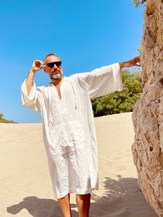 Hand made From start to finish Linen and cotton mixed lightweight fabric night gown for men Mens natural fabric caftan It's a special kind of linen which is only made in Anatolia ( i uploaded the fabric's detailed picture ) Lightweight White color Plus size avalible Small/medium/large/ xlarge / 2XL / 3XL / 4XL / 5XL size options Feel free to Ask for custom made Front pocket - kangaroo pocket Gift for him Super comfortable men's clothing to wear at home or outdoor Linen outfit Nightgown Pool part Casual Summer Tunic Thobe, Casual Tunic Thobe For The Beach, Casual Long Thobe For Vacation, Summer Festival Thobe Tunic, Summer Festival Tunic Thobe, Casual Summer Vacation Thobe, White Long Thobe For Summer, White Summer Thobe, Oversized Beach Thobe In Tunic Style