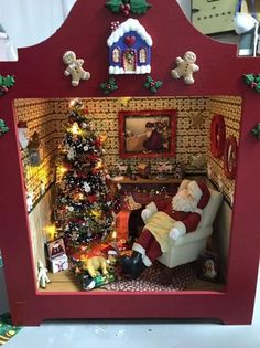 a christmas scene with santa claus sitting in a chair and other decorations on the wall