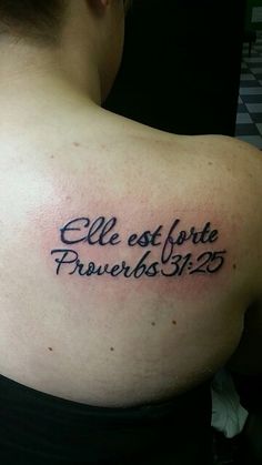 the back of a woman's shoulder with an inscription on it that says, ell est forte preverbos siz