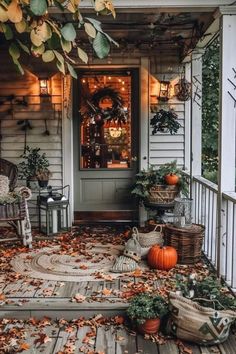 a porch covered in fall leaves and pumpkins