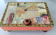 a small wooden box covered in lots of different types of stamps and other things on it