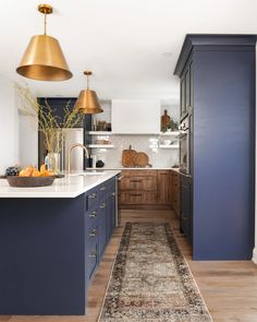 a kitchen with blue cabinets and an area rug on the floor that says happy new year