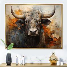 a painting of a bull with large horns is on the wall next to a vase