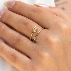 Crafted with precision and care, this dainty ring features a delicate arrow motif in genuine solid gold, adding a touch of sophistication to any ensemble. Its twist double wrap design offers a unique twist on traditional ring styles, perfect for stacking and layering with your favorite pieces.  *Free Express International Shipping NEXT BUSINESS DAY SHIPPING! PRODUCT DETAILS *The product is made of 100% 14k Solid Gold and it has a 14K or 585 stamp on item.  *(We don't sell filled or plated jewelry) *The photos above is showing that the ring is on index finger, but you can use this ring on every finger you want. But we suggest to wear it on index finger, thumb and middle finger. *The package includes a gold certificate.  *Every package comes in a gift box. *14K gold indicates that the produc Gold Ring Band, Layering Jewelry, Gold Arrow, Gold Certificate, Arrow Ring, Zierlicher Ring, Wrap Ring, Layered Jewelry, Wrap Rings