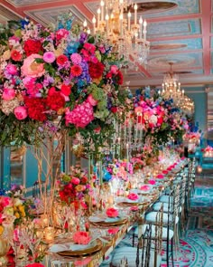 a long table is set with flowers and candles for a formal dinner or banquet event