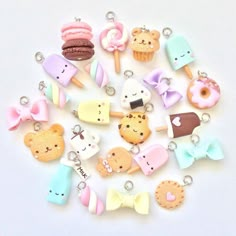 a bunch of cute little charms on a white surface