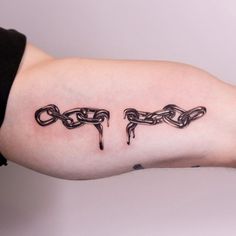 a person's arm with chains on it and the word love written in black ink