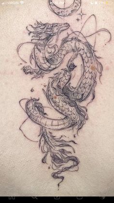 a dragon tattoo on the back of a woman