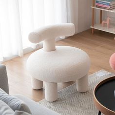 a living room with a couch, chair and coffee table in front of a window