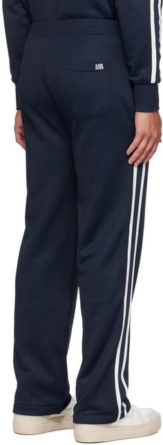 AMI Paris.SSENSE Exclusive Navy Track Pants.Nylon- and cotton-blend French terry track pants..· Concealed drawstring at elasticized waistband.· Three-pocket styling.· Stripes at outseams.· Embroidered logo patch at back pocket.Available exclusively at SSENSE..Supplier color: Lazuli blue.60% polyamide, 40% cotton..Made in Bulgaria..231482M190009 Navy Sporty Sweatpants With Elastic Waistband, Sporty Navy Sweatpants With Elastic Waistband, Sporty Bottoms With Elastic Cuffs And Straight Hem, Sporty Pants With Elastic Cuffs And Straight Hem, Sportswear Lounge Pants With Side Stripes, Sporty Straight Leg Pants With Elastic Cuffs, Sporty Pants With Elastic Cuffs And Straight Leg, Sporty Joggers With Drawstring, Sporty Sweatpants With Ribbed Cuffs In Straight Cut