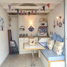 a small kitchen with blue and white decor on the walls, along with lots of wood flooring