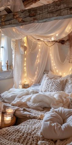 a bed with white sheets and lights on the headboard