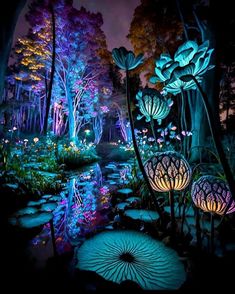 the garden is lit up at night with colorful lights and water lilies in it