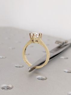 a diamond ring sitting on top of a table