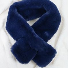 a blue scarf laying on top of a white blanket