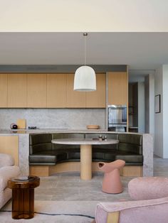 a living room filled with furniture next to a kitchen and dining area in the background