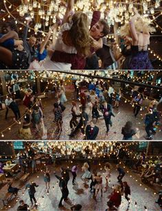 people are dancing on the dance floor in front of lights and chandeliers at a party