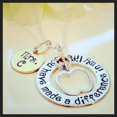 two necklaces with words on them sitting on a table