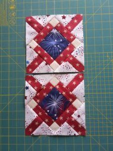 two red, white and blue quilts on a cutting board