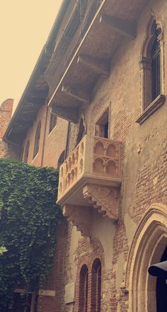 an old brick building with balcony and balconies