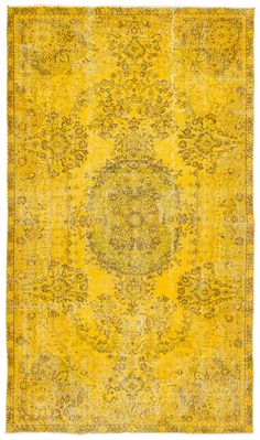 an antique rug with yellow and green colors