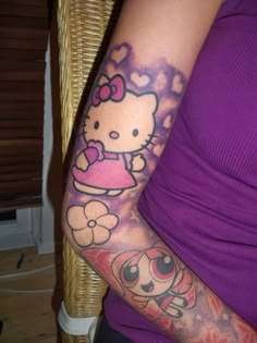 a hello kitty tattoo on the arm of a woman's right arm and left arm