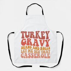 a white apron that says turkey gravy bears and rolls let me see that casserole