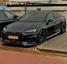 two black cars parked next to each other