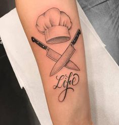 a chef's hat and knife tattoo on the left inner arm with words life