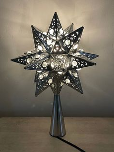 a star shaped lamp is lit up on a table