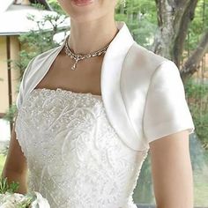 a woman in a white dress holding a bouquet