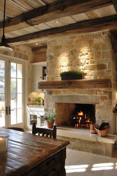 a stone fireplace in a kitchen next to a table with chairs and potted plants