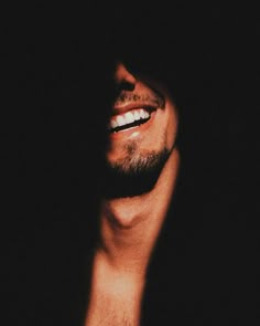 a close up of a person with his mouth open and teeth whitening in the dark