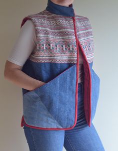 a woman wearing a blue jean vest with red trim