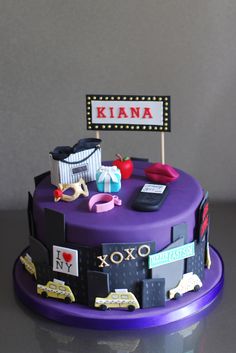 a purple cake with various items on it