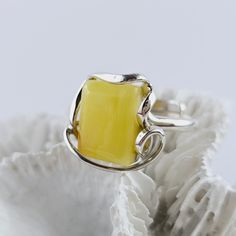 Natural Yellow Baltic Amber Ring, Yellow Amber Ring, Amber And Sterling Silver Ring, Baltic Amber Jewelry, Amber Gift For Her, Yellow Amber Amazing adjustable ring made of natural Baltic amber and sterling silver. Yellow Baltic Amber ring. Really stunning,  Baltic amber ring in a beautiful yellow color. This handmade ring is made of 100% natural, polished Baltic amber and sterling silver. Weight: 7.82 g Dimensions: approx. 1,7 x 1,9 x 0,7 cm / 0.66 x 0.74 x 0.27 inch Size: adjustable Sterling silver 925 It's a handmade product, each item is unique. Great as a gift. Each of our products is packed in a beautiful gift box. Baltic amber manufacturer and seller from Poland. Our jewelry, beads and other goods shop: https://www.etsy.com/shop/FineBalticJewelry Shipping time to your country: Europe Yellow Rectangular Ring As A Gift, Yellow Rectangular Ring For Gift, Yellow Rectangular Rings For Gift, Yellow Sterling Silver Open Ring, Untreated Amber Jewelry Gift, Unique Handmade Yellow Rings, Sterling Silver Yellow Cabochon Rings, Unique Yellow Jewelry Ring, Unique Yellow Ring Jewelry