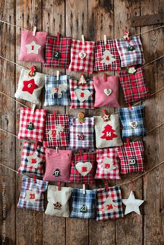 many small red and white plaid bags hanging from clothes pins on a line with stars