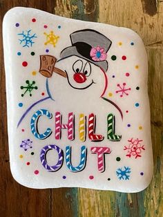 a snowman with a hat and top hat on it's head that says chill out