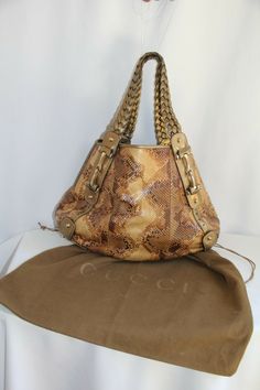 Gucci Pelham Medium Python Bag. RARE Gorgeous Color Metallic Gold Braided Leather Straps with Gold Bit Hardware On This Beautiful Brown/Tan/Gold Python Hobo Bag. Perfect Medium Size: 17” length x 12” height x 5” width. Top Open Access with Strap Loop Snap. Inside Sued Lining and Large Zip Pocket. Gold Stud Feet. Gucci Dust Cover Included. Gucci Signature Logo and Authentication Numbers.  Photos Are Actual Of This Bag. Some Minimal Normal Wear (see photos). Bag is in Great Condition. Smoke/Pet Fr Vintage Gucci Tote Shoulder Bag, Gucci Rectangular Gold Bag, Gucci Gold Rectangular Bag, Gucci Gold Leather Bag, Gold Gucci Leather Bag, Gold Rectangular Gucci Bag, Rectangular Gold Gucci Bag, Gucci Gold Tote Shoulder Bag, Gucci Gold Satchel Shoulder Bag