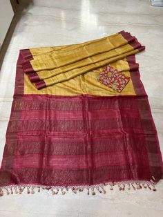 This beautiful Pure Gachhi Tussar silk saree with zari check on whole body snd zari red pallu with red zari border . A beautiful combinations of yellow and red .  Saree comes with kalamkari hand painted blouse piece of the border colour.   Fall and edging complimentary . Saree has silk mark certificate . Red Tussar Silk Traditional Wear With Kalamkari Print, Red Raw Silk Traditional Wear With Kalamkari Print, Raw Silk Kalamkari Print Saree For Puja, Diwali Raw Silk Saree With Kalamkari Print, Red Raw Silk Dupatta With Kalamkari Print, Red Kalamkari Print Raw Silk Saree, Raw Silk Saree With Kalamkari Print, Red Katan Silk Saree With Kalamkari Print, Kalamkari Print Slub Silk Saree For Puja