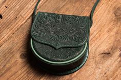 This small green shoulder bag is handmade of cow's leather and processed with manual blanking and piercing method. Your Messenger bag is inspired by unique ethnic style of Carpathian culture, provides great comfort and style and will become a great gift.Dimensions: 16 cm / 6"16 cm / 6"6 cm / 2.2" Strap length 140 cm / 55"Weight 350gr/12ozSoft leather inside lining*Slight deviations from the pictures (leather hue, color of inner lining) may occur. Please make sure You inform us in advance if You Green Shoulder Bag, Crafted Bag, Wooden Bag, Purple Purse, Ethnic Bag, Unique Handbags, Hue Color, Bags Leather Handbags, Brown Leather Shoulder Bag