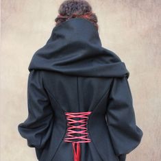 📏 made to order in your size 🎨 black ✂️ 100% wool 🚿 dry clean ⏰ 4-5 weeks Straight out of a fairy tale, this coat makes a statement with its large hood and ribbons laced up the back. Made from 100% black wool and lined with cotton poplin, it's very warm. It features 2 front patch pockets. Doubled, tightened cuffs protect against air infiltration. (Photo shows coat worn with plum mittens). It closes like a wrap-around thanks to large ribbons. An olive button closes the neckline... Its plunging Fitted Fantasy Outerwear For Winter, Fitted Fantasy Winter Outerwear, Fantasy Style Fitted Fall Outerwear, Fantasy Hooded Outerwear For Fall, Fitted Fantasy Outerwear For Fall, Fitted Fantasy Style Outerwear For Fall, Fantasy Hooded Fall Outerwear, Black Fantasy Outerwear For Winter, Black Fantasy Style Winter Outerwear