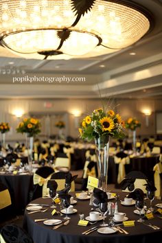 the tables are set up with sunflowers in vases