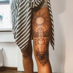 a woman's legs with tattoos on them and an all seeing eye tattoo on the lower leg