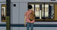 a man with a backpack is waiting for the train